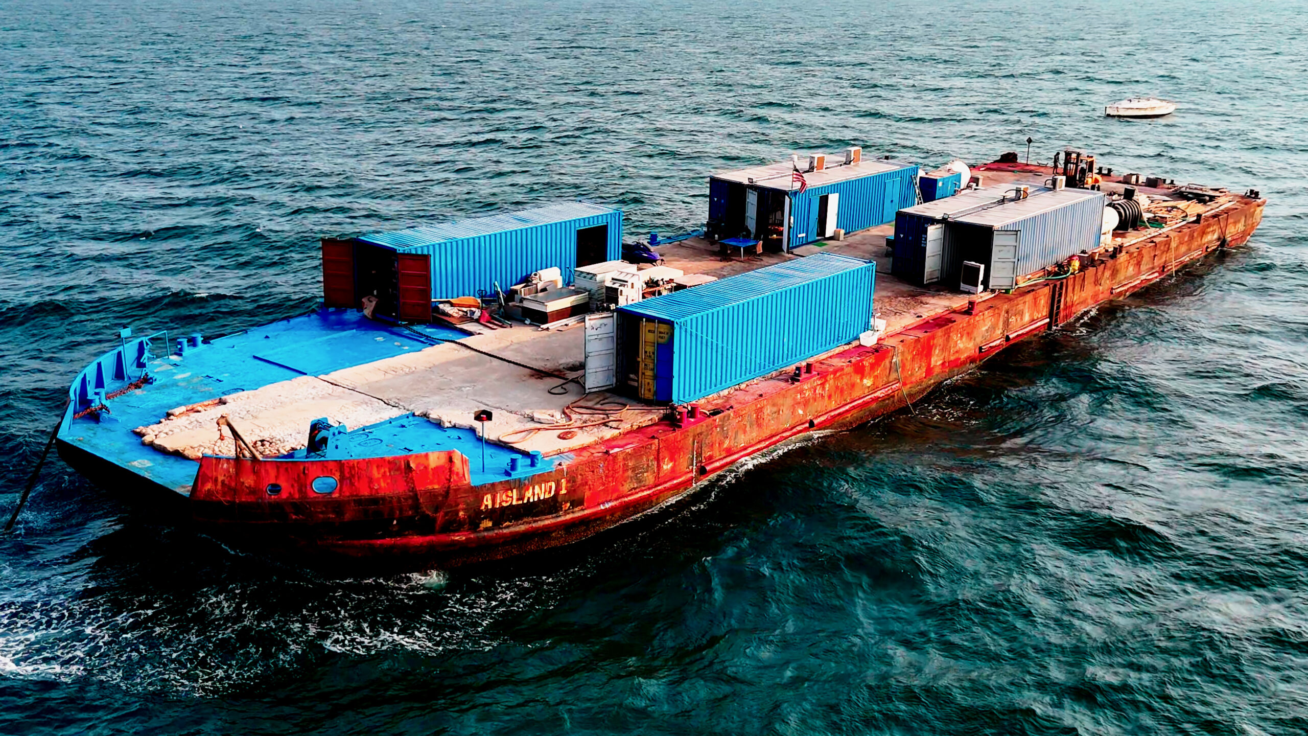 In 2022, Samuele Landi bought an initial 800-ton deck barge that he named Aisland and anchored roughly 30 miles off the coast of Dubai, where he lived with three sailors, a cook and five cats.